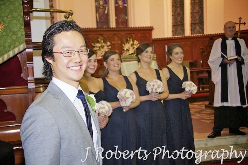 Groom smiling at Bride arrives at the church - wedding photography sydney